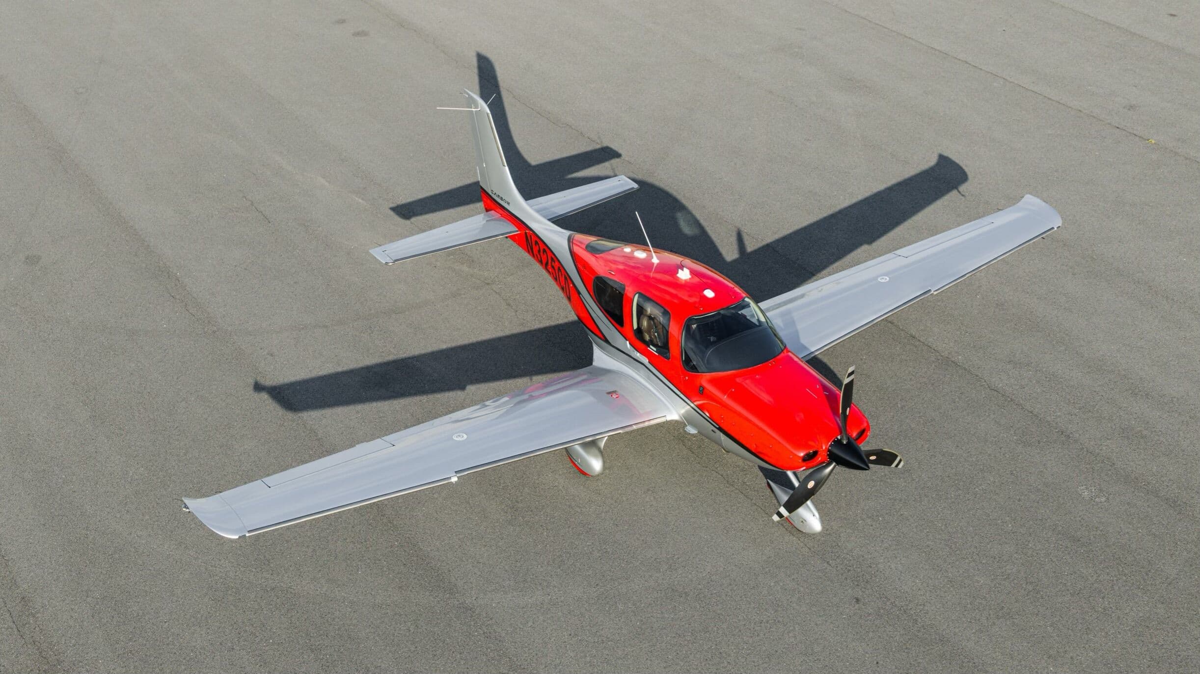 A Cirrus SR22 photographed from above on the ramp